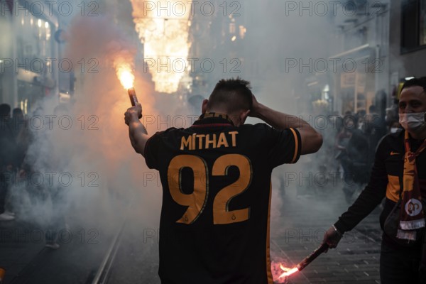 Istanbul, Turkey. November 21st 2021 Turkish Galatasary football supporters light flares in Taksim