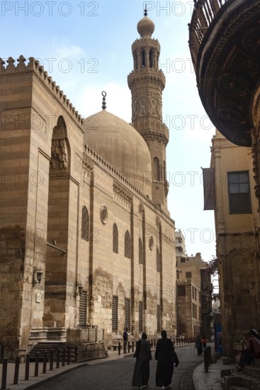 Cairo, Egypt. July 7th 2024 Locals and tourists walk past one of the many restored monuments along