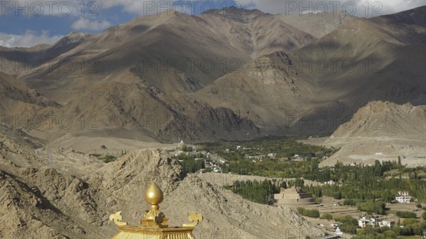 View of a valley with Buddhist buildings and surrounding mountains, trekking in Ladakh, Himalayas,
