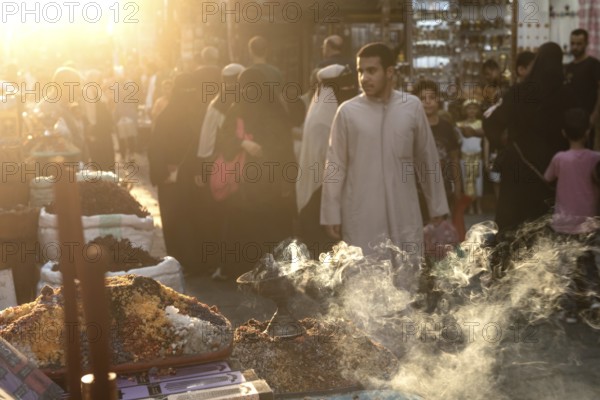 Cairo, Egypt. July 2nd 2024 Smoke from burning incense in a busy market in the historical Islamic