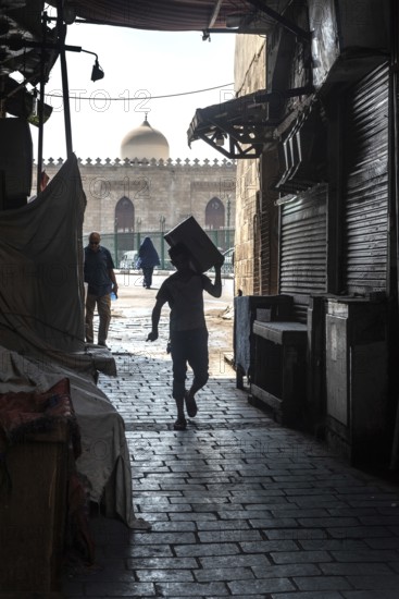 Cairo, Egypt. July 1st 2024 Workers in the narrow cobbled alley ways of Islamic Cairo near the