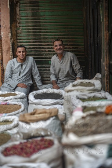 Cairo, Egypt. July 1st 2024 Two Egyptian men sit amongst sacks of spices in the Cairo spice market
