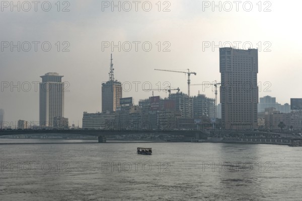 Cairo, Egypt. July 1st 2024 Building and construction cranes of the Cairo city skyline seen through