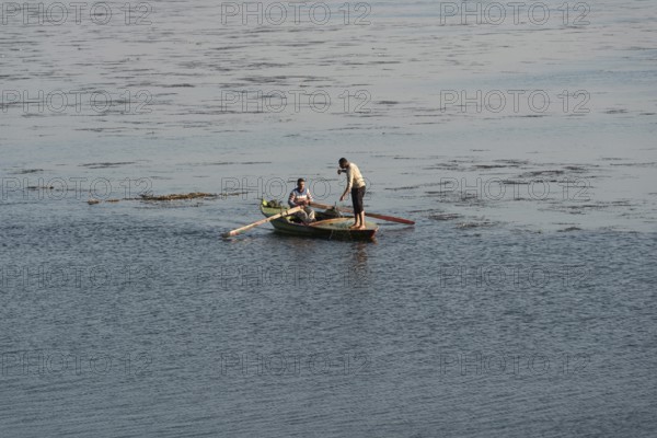 Qanater, Nile Delta. Egypt. December 18th 2022 Egyptian fishermen fishing from a small boat on the