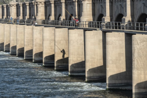 Qanater, Nile Delta. Egypt. December 18th 2022 Egyptian men fishing from the El Qanater Barrage, on