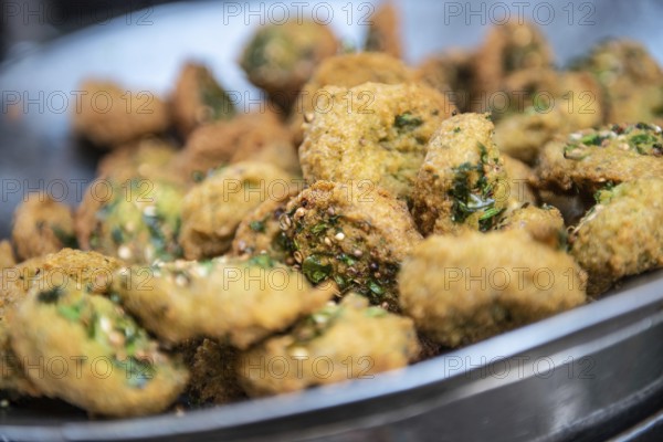 A close up detail of freshly cooked deep fried Falafel, a chickpea and herb filled snack popular in