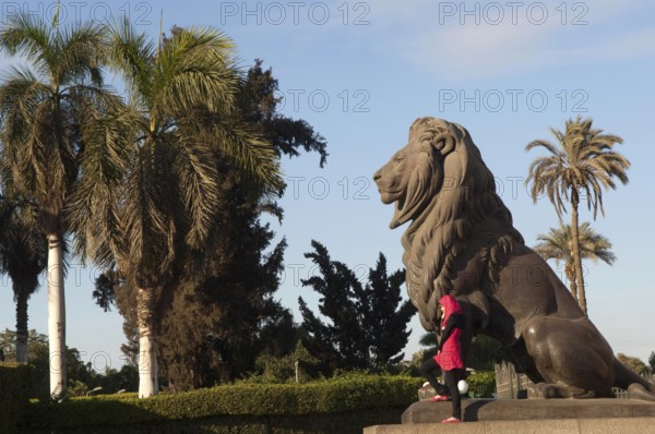 Cairo, Egypt. December 10th 2009 Young Egyptian Muslim women poses for photographs beside a statue