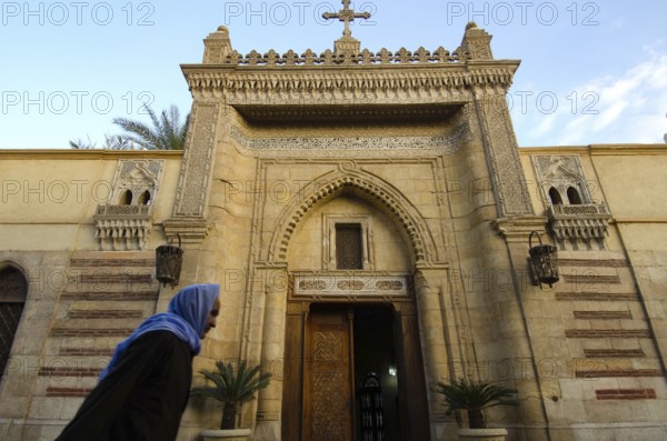 Cairo, Egypt. December 31st 2012 An Old Egyptian Copt walking past the entrance to the Hanging