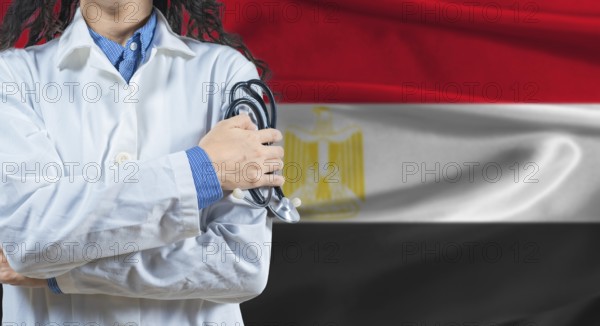 Healthcare professional with Egypt flag background. Professional doctor holding stethoscope on