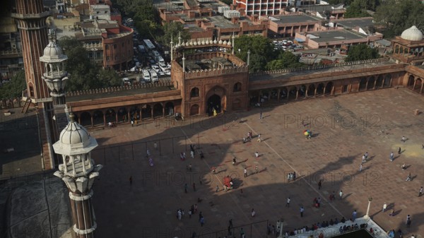 View from above of the Jama Masjid Historic Mosque in an urban setting with people and