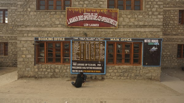 Ladakh bus operator cooperative stone building with signs and street view, Leh, Ladakh, North