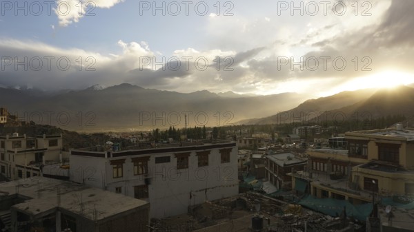 Leh in the evening light with mountains in the background and clouds covering the horizon, Ladakh,
