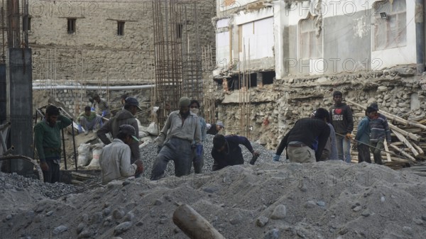 Workers on a construction site in Leh working on a building in harsh conditions, Ladakh, North