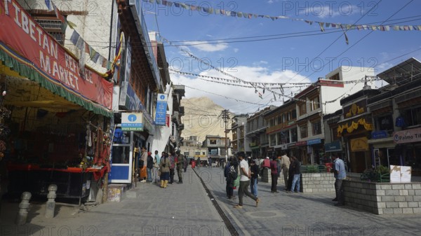 Busy street in Leh with traditional shops and flying prayer flags, Ladakh, North India, Himalayas,