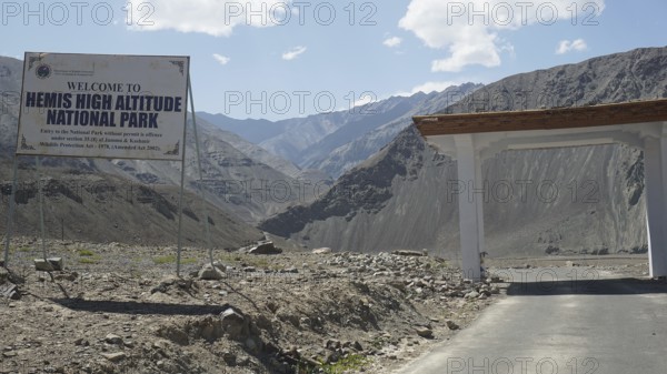 Entrance gate to Hemis National Park with sign and mountainous surroundings, Ladakh, Himalayas,