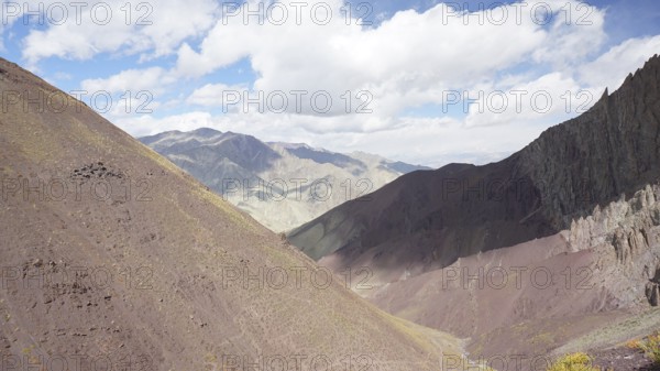 Mountain landscape with soft colors under a partly cloudy sky, trekking at Stok La Pass in Ladakh,