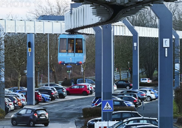 The H Bahn, an automatically controlled large cabin suspension railway above the parking lot of the