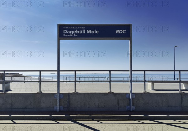 Dagebüll Mole sign of the Norddeutsche Eisenbahn Niebüll with a view of the North Sea,