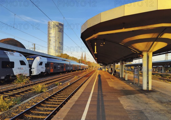 On the train track with a view of the Cologne Triangle skyscraper at sunrise, Deutzer Bahnhof,