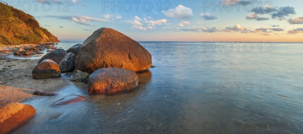 Coastal landscape with large boulders on the Baltic Sea beach in the evening light, Mönchgut Nature