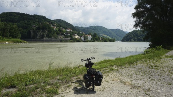 Cycling on the banks of the Danube with rolling hills and clouds, cycling on the long-distance