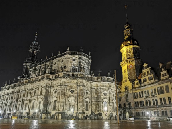 Night view of an illuminated cathedral and a distinctive tower with historic flair in the historic