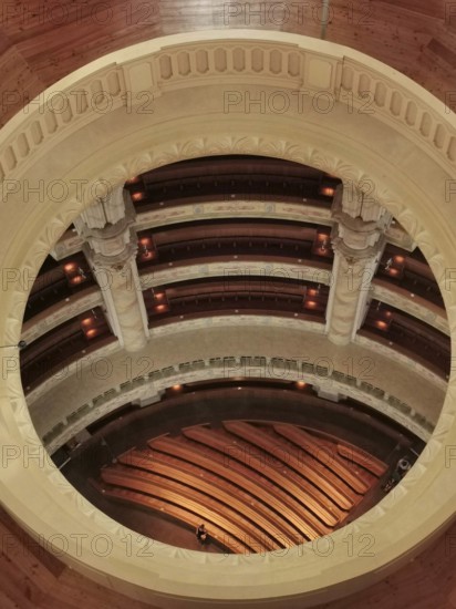 View of a round, elegant interior with wooden floors and rows of seats, Dresden