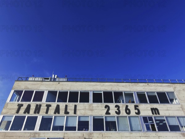 Building at the summit of Tahtali Dagi and altitude 2365 meters, under a deep blue sky, climbing
