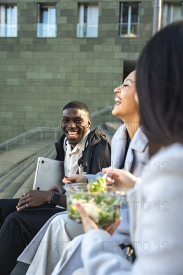 Diverse group of friends or colleagues enjoying a happy moment together outdoors, laughing and