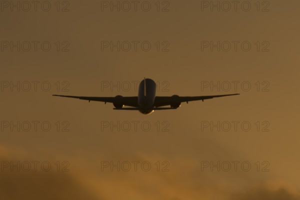 Boeing 777 A7-BFL commercial jet aircraft of Qatar cargo taking off in flight silhouette at sunset