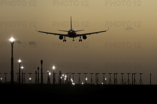 Airbus 320 commercial passenger airliner jet aircraft in flight on approach to land over runway