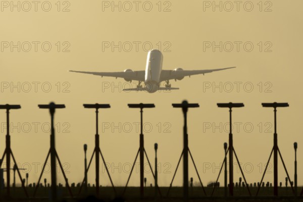 Commercial passenger airliner jet aircraft taking off in flight at sunset at London Stansted