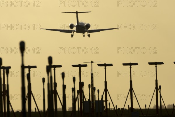 Cessna Citation small executive business jet aircraft in flight on approach to land over runway
