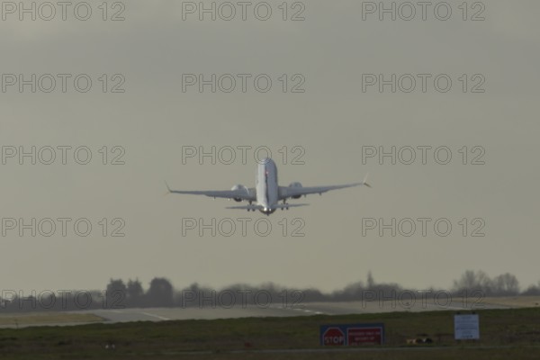 Boeing 737 commercial passenger airliner jet aircraft taking off in flight at London Stansted