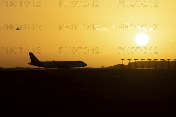 Airbus commercial passenger airliner jet aircraft taking off in flight with another plane on the