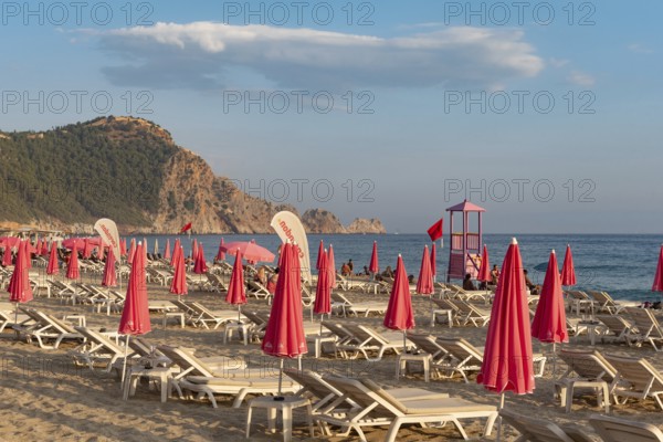 Alanya, Turkey. July 9th 2024 Sunbeds and pink sunshades on Cleopatra Beach in the Turkish holiday