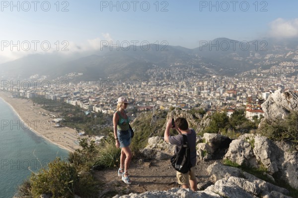 Alanya, Turkey. April 7th 2021 Tourists posing for photographs on the mountain overlooking the city
