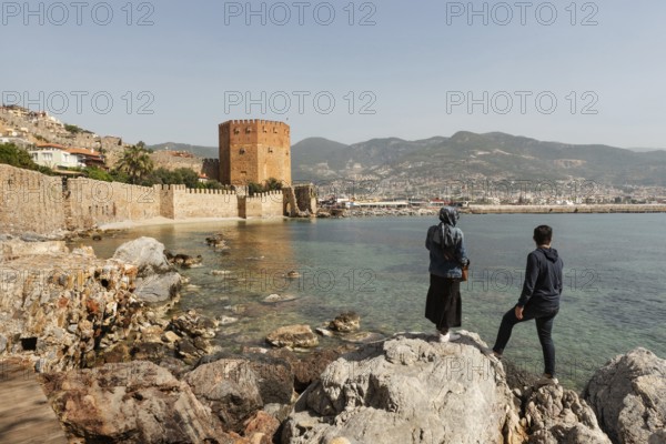 Alanya, Turkey. April 7th 2021 Turkish tourists enjoy the view of the ancient walls of Alanya