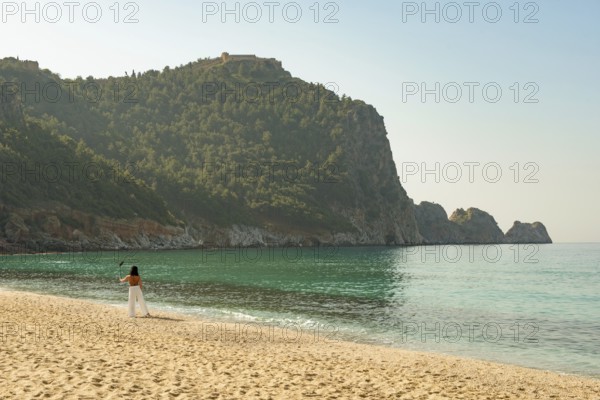 Alanya, Turkey. April 7th 2021 Beautiful woman taking a selfie on a bright sunny Kleopatra beach in