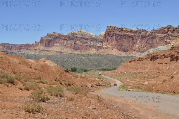 Extensive road through a landscape of red rocks and clear blue sky, Capitol Reef National Park,