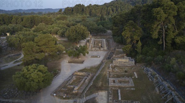 Soft morning light, Temple of Hera, ruins and thick forests in hilly surroundings, drone shot,