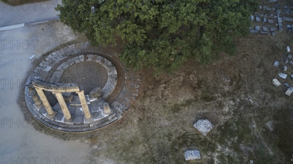 Philippeion, aerial view of ancient column formation and surrounding trees, drone view,