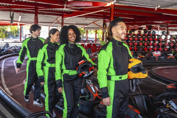 Group of diverse young adults wearing racing suits, carrying helmets, and smiling while walking