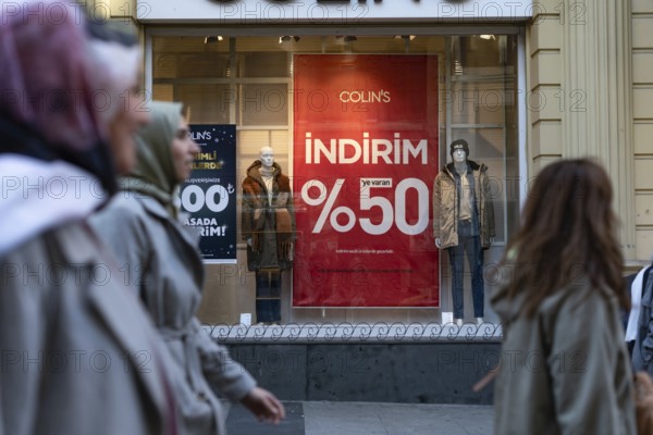Istanbul, Turkey 7th January 2025. 50% Sale prices displayed in shop window in a busy shopping