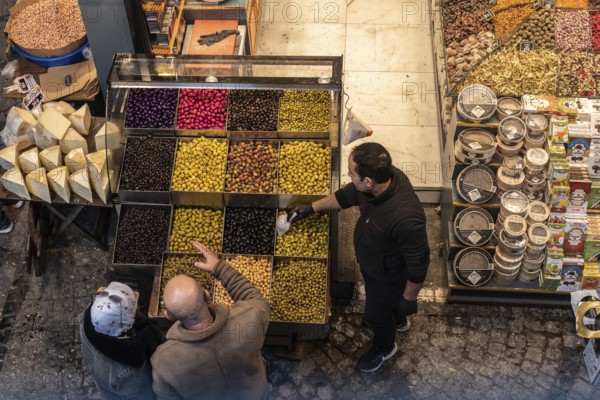 Istanbul, Turkey 7th January 2025 . Shoppers buying olives in a popular Turkish market near the