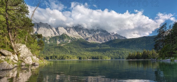 View over Lake Eibsee lake, the Wetterstein Mountains with the Zugspitze in the background, clouds