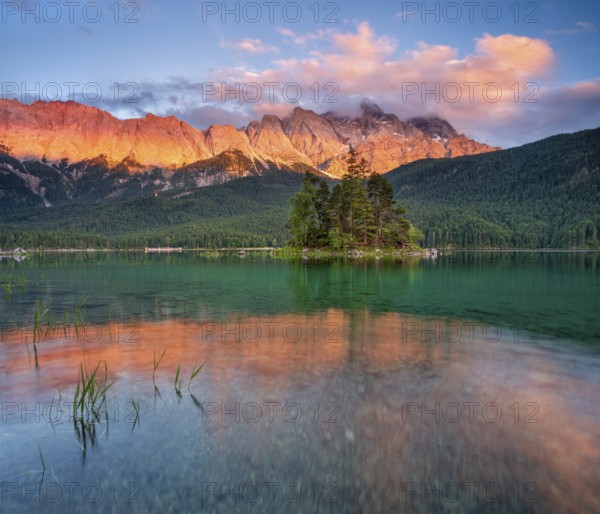Evening atmosphere on Lake Eibsee lake with alpine glow, in the back the Wetterstein Mountains with