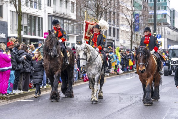 Rose Monday procession in Düsseldorf, group of horses at the street carnival, sometimes heavy rain,