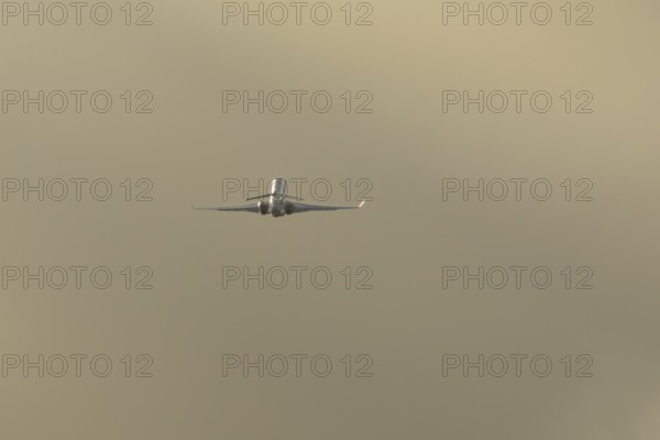 Gulfstream executive business jet aircraft in flight at sunset at London Stansted airport, Essex,