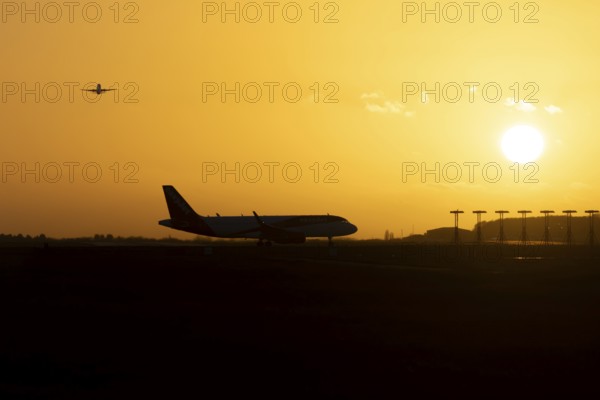 Airbus commercial passenger airliner jet aircraft taking off in flight with another plane on the